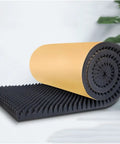 Top Tier Self Adhesive Acoustic Foam Panels Sick Soundproofing Tiles For Home Studio And Music Room Wall Sound Dampening Pads Low Odor Polyurethane Egg Crate Design Mat Black rolled up partially on a flat surface.