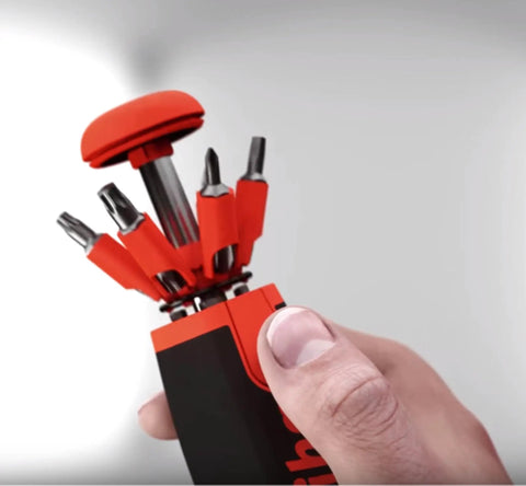 Hand holding 26InOne Ultra Driver Set 14 Piece Kit With Magnetic Bits And Precision Screwdrivers For Home Auto And Workshop Use Built Tough Versatile Hand Tool Collection