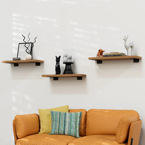 Three wall-mounted shelves using Ten Inch Floating Shelf Brackets Four Pack Heavy Duty Rustic Industrial Hidden Metal Mounts One Fifth Inch Thick T Type Design Above a sofa.