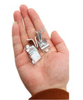 Close-up of hand holding 14 Piece Silver Adjustable Steel Shelf Clip Supports For Metal And Wood Shelves, pilaster bracket clips.