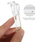 Thirty Piece Set Of Transparent Valance Clips For Window Blinds 2.5 Inch hidden track holder in hand, clear durable plastic design.