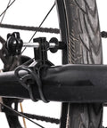 Close-up of Ultra Portable Bike Wheel Truing Stand for On The Go Rim Adjustment clamped on bike wheel.