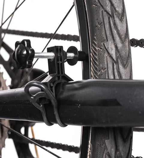 Close-up of Ultra Portable Bike Wheel Truing Stand for On The Go Rim Adjustment clamped on bike wheel.