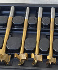 Top Shelf 7 Piece Multi Curve Angle Forstner Drill Bit Set With Heavy Duty Titanium Coating displayed in a black case.