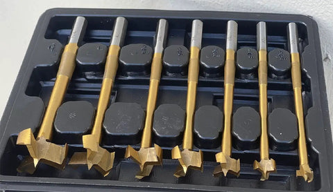Top Shelf 7 Piece Multi Curve Angle Forstner Drill Bit Set With Heavy Duty Titanium Coating displayed in a black case.