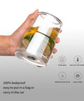 Real Deal Double Wall Glass Tumbler 13 Oz Heat Insulated Water Cup held with lemon slices inside, showcasing glass material and dual temperature insulation.