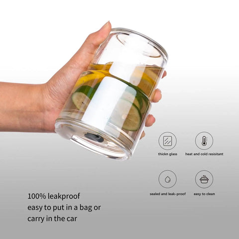 Real Deal Double Wall Glass Tumbler 13 Oz Heat Insulated Water Cup held with lemon slices inside, showcasing glass material and dual temperature insulation.