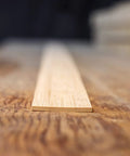 Close-up of flattened bamboo for bow making and woodworking build bows and bendable projects, showing texture and grain details.