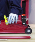 DEDC universal aluminum grooved magnetic jack pad on a red floor jack beside a car wheel