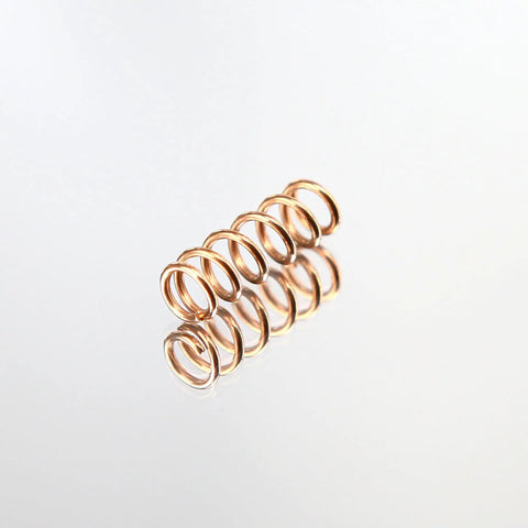 Single copper compression spring from 10 Pack Copper Compression Springs For Automotive Heating Plug, 5.3mm Outer Diameter and 16mm Length.