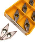 Durable Indexable Carbide Lathe Tool VCMT160408 with sharp edges in a tray, ideal for external turning steel and cast iron.