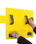 Person using a yellow safety rescue training tool with handles for emergency evacuations.