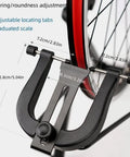 Close-up of Foldable Bike Wheel Truing Stand For 16 To 29 Inch Wheels calibration gauge setup on bike wheel.