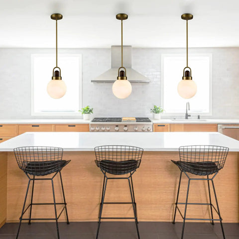 Mid Century Brushed Brass Globe Pendant Light with Milk Glass Shade for Kitchen Island, modern fixture above counter.