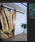Handcrafted Live Edge Spalted Hackberry Barn Door With Custom Sizing Made To Order In Minnesota Totally One Of A Kind Rustic Modern Wood Door For Hallway Or Entryway shown installed on hallway wall.