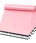 Stack of self seal poly mailer bags, 100 pack, fourteen point five by nineteen inch tearproof shipping envelopes in light pink, shown unfolded.