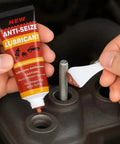 Applying copper anti-seize brake lubricant to spark plug threads for high-temp protection