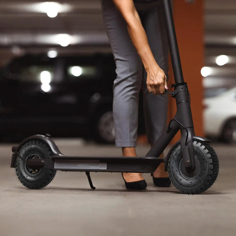 Person fixing a scooter in a garage with emphasis on the tire resembling Two Pack 4.10/3.50-4 Tire And Inner Tube With Bent Valve Stem