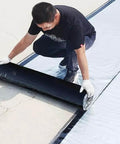 Man applying Heavy Duty Synthetic Roof Underlayment And Self Adhesive Waterproof Membrane With Thick Silver Foil on surface.