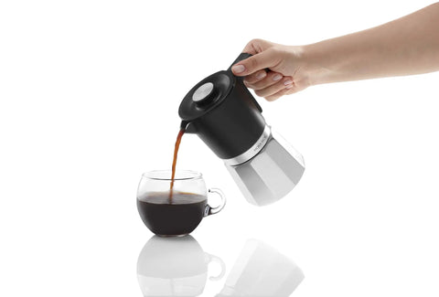 Dope All In One Turkish Coffee And Moka Pot With Milk Frother, Dual Brew Machine pouring coffee into glass cup, chrome finish.