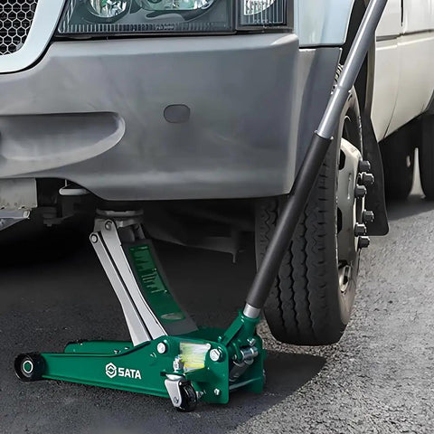 Green 3 Ton Hydraulic Floor Jack under vehicle, used for lifting, demonstrating the Heavy Duty Steel Return Springs For Horizontal Jack Handle Replacement Parts Torque Reset Spring Set 4 Pack Durable DIY Mechanic Upgrade Ideal For DIY Enthusiasts
