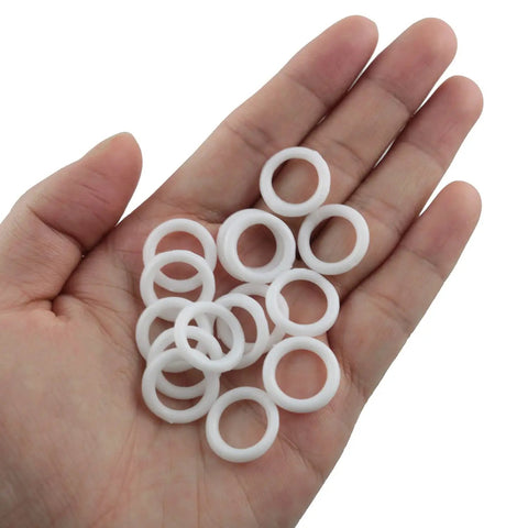 200 Piece Clear Plastic Curtain Rings For Roman Shades And Cafe Blinds Featuring Hardcore Durability on a hand, showing multiple white loops.
