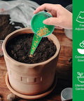 Hand holding green seed dispenser from Six Piece Mini Seed Spreader Set For Tiny Seeds Handheld Sowing Dispenser with Dibber and Widger