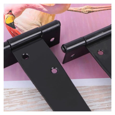 Close-up of black iron Beefy Heavy Duty T Shape Door Hinges With Screws 2 Inch, showing triangular design on pink background.