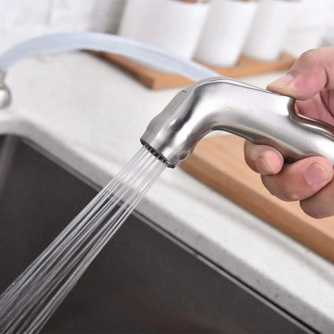Brushed Nickel Kitchen Faucet With Side Sprayer And High Arc Two Handle Design For 3 Or 4 Hole Sinks Includes Water Supply Line And Easy Install Tool Built From Durable Stainless Steel 13.38 Inch Overall Height And 9.44 Inch Spout sprayer in use.