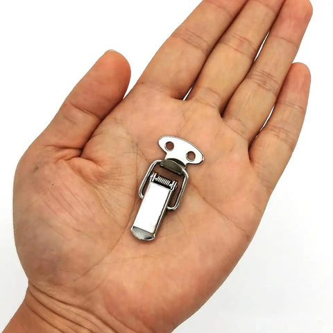 Person holding a 10 Pack Stainless Steel Spring Loaded Toggle Latches For Cabinets Boxes Chests And Wooden Cases Small Clamp Clips