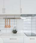 Two Pack 3.75 Inch Brushed Satin Nickel Cabinet Handles installed on white kitchen cabinets