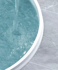 Water flowing over the edge of a marble basin demonstrating 122 Inch Shower Threshold Water Dam Collapsible Barrier Spill Proof