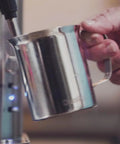 Close-up of Stainless Steel Espresso And Coffee Maker Duo Brew Kit With 10 Cup Capacity 19 Bar ULKA Pump steaming milk