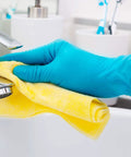 No Sweat Blue Nitrile Exam Gloves Case Of One Thousand Large Size Packs Latex Free Powder Free Formulation With Slick Tactile Feel and Dead Reliable Allergy Safe Shield For Medical Crews Demanding Top Tier Performance Every Shift cleaning a faucet with a yellow cloth.
