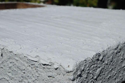 Close-up of Brushable Chimney Crown Repair Elastomeric Waterproof Coating for Crowns and Masonry Flexible Sealant on a chimney surface.