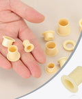 Hand holding 8mm ID 10mm OD Flanged Sleeve Bearing Kit POM Plastic Bushing 15mm Length Yellow 8 Pack Durable For Precision And Quiet Operation In Small Machines For DIY Projects