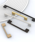 Variety of cabinet handles in brushed nickel, bronze, and gold finishes displayed on a plate