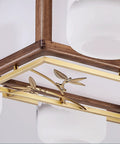 Close-up of Straight Up Smooth Rectangular Wooden Pendant Light With Black Walnut Finish showing golden details and frosted glass.