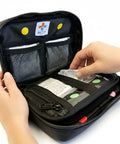MediKit medical kit in black zip case, open to pill packets and mesh inner pockets