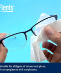 Flents Lens Wipes for glasses; blue background, hands wiping eyeglass lenses with a wipe.