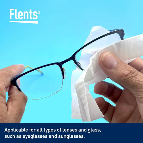 Flents Lens Wipes for glasses; blue background, hands wiping eyeglass lenses with a wipe.