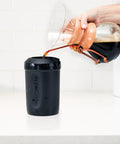 Hand pouring coffee into Patented Iced Coffee And Beverage Cooler That Chills In One Minute, Reusable, Black, 12.5 Oz