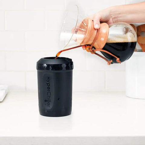 Hand pouring coffee into Patented Iced Coffee And Beverage Cooler That Chills In One Minute, Reusable, Black, 12.5 Oz