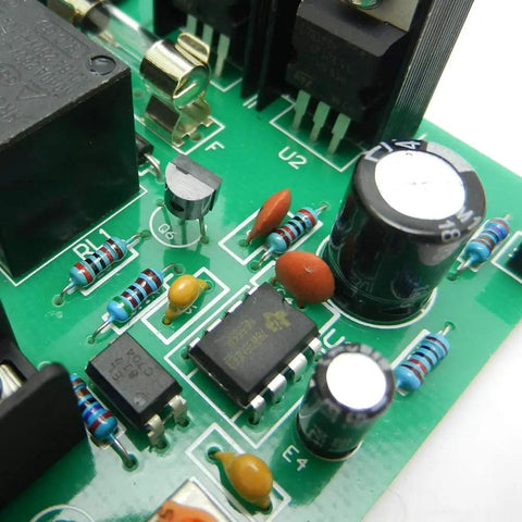Close-up of resistors and capacitors on a circuit board, part of the 2600 Piece Resistor Kit With 130 Values 1 Ohm To 3M Ohm 0.25W Metal Film Resistors 1 Percent Tolerance Axial Lead Ideal For DIYers And Pros Great For All Kinds Of Electronics Builds.