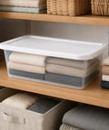 Clear Plastic Storage Bins With White Snap On Lids Set Of Ten Six Quart Capacity on shelf holding neatly folded blankets.