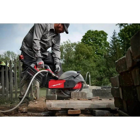 Heavy Duty 14 Inch Cordless Power Cut Off Saw Built Like A Tank For Knocking Out Clean Slots In Concrete And Steel Rebar With Instant Kickback Guard and Push Button Activation in action cutting through concrete.