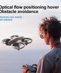 Palm Sized FPV Drone With Dual Cameras For Beginners floating near a user, showing optical flow and obstacle avoidance in outdoor setting.
