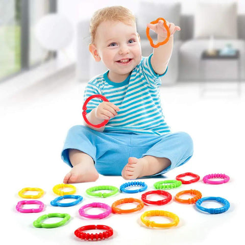 Child playing with Link To Go Baby Rings Toy Kit For Stroller Car Seat Crib Clip On Play Mat Early Education Set, 18-Piece Colorful Sensory Rings For Infants And Toddlers, Travel Accessory That Sparks Touch Sight And Learning.