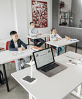 Hands On Solar Windmill Kit For Kids Easy Assembly Mini Wind Turbine on classroom desk beside laptop in educational setting