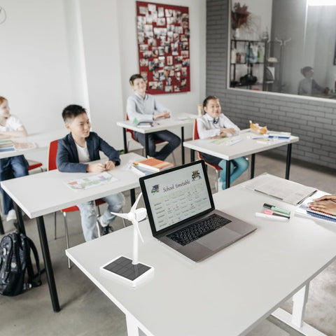 Hands On Solar Windmill Kit For Kids Easy Assembly Mini Wind Turbine on classroom desk beside laptop in educational setting